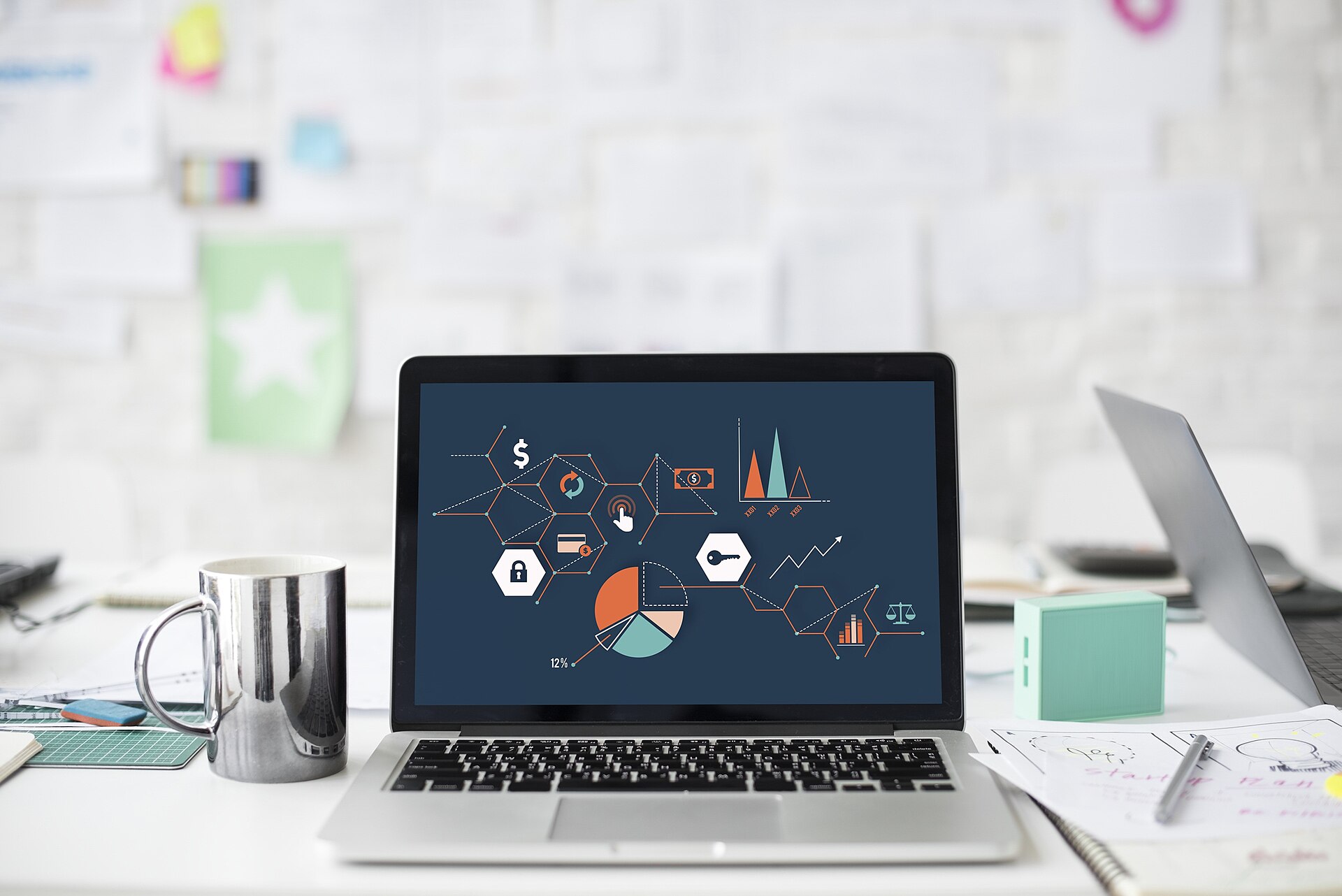 Laptop screen showing colorful charts on a desk